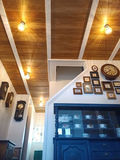 a room with wooden ceilings and pictures on the wall