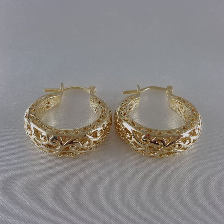 Step into the world of elegance and style with our stunning Gold Plated Filigree Hoop Earrings. Designed to make a statement, these earrings add a touch of glamour to any ensemble. Get ready to turn heads and feel fabulous!Inner diameter: 18mm - 11/16 in.Outer Diameter: 25mm - 1 in.Width at the bottom: 9mm - 3/8 in. Filigree Hoop Earrings, Gold Plate, Hoop Earrings, Plating, Turn Ons, Gold