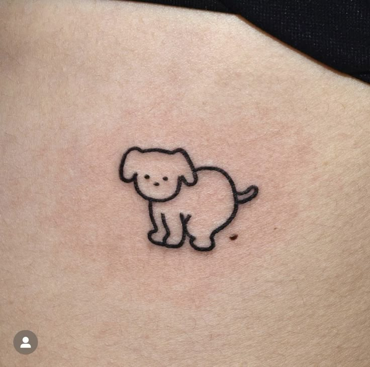 a small elephant tattoo on the side of a woman's stomach, it is black and white