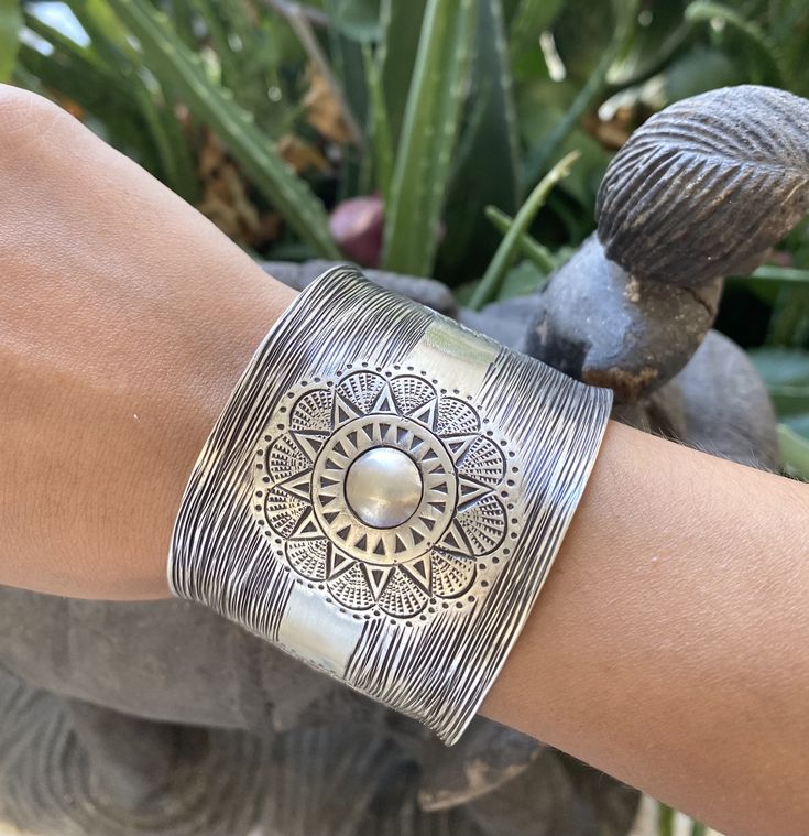 "❋ Handmade Sterling Silver Wide Boho Statement Cuff with Engraved Oxidized Silver Solar Mandala ❋ Dimensions: Width: About 1.5\" (3.8 cm), Length: About 6.9\" / 17.5cm ❋ Metal Purity: 95% Pure Silver (Purer than 925 Sterling Silver) To browse some more of our Silver Jewelry collection you can click on the following links: https://www.etsy.com/shop/SilverShapes Earrings: https://www.etsy.com/shop/SilverShapes?section_id=14809462&ref=shopsection_leftnav_1 Rings: https://www.etsy.com/shop/Silv Artisan Bangle Cuff Bracelet For Festivals, Adjustable Oxidized Cuff Bracelet For Festivals, Artisan Oxidized Bangle Cuff Bracelet, Artisan Oxidized Finish Cuff Bangle Bracelet, Bohemian Cuff Bracelet For Ceremonies, Bohemian Bangle For Rituals, Bohemian Adjustable Cuff Bracelet With Intricate Design, Artisan Silver Cuff Bracelet For Festival, Bohemian Silver Cuff Bracelet For Festival