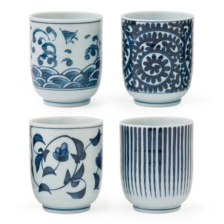 four blue and white cups with designs on them