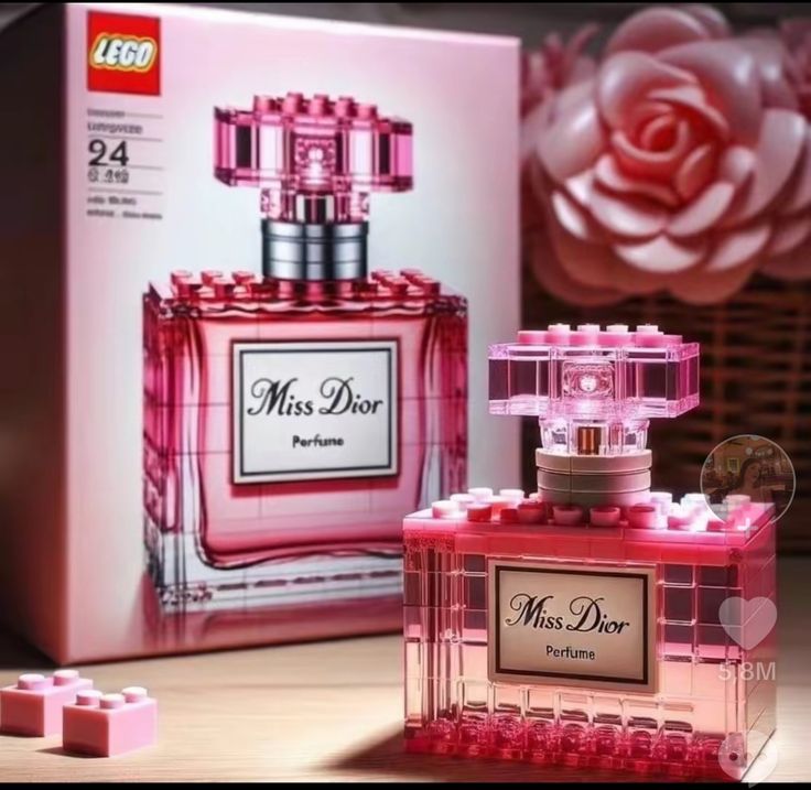 a pink perfume bottle sitting next to a box