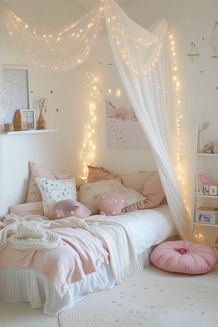 a white bed with pink pillows and lights on the headboard, in a girls'bedroom