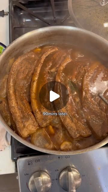 a pan filled with food sitting on top of a stove