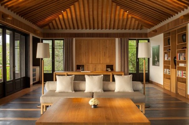 a living room filled with furniture and lots of windows