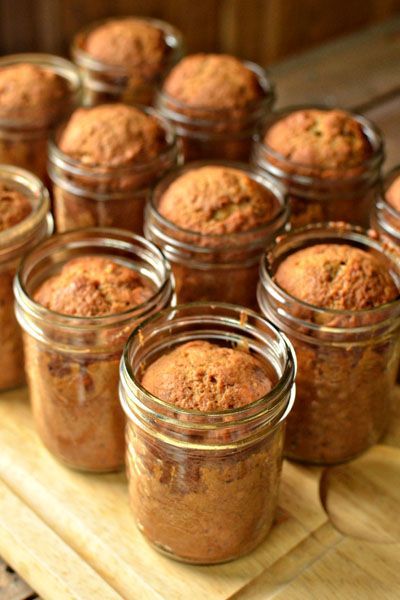 many jars filled with food sitting on top of a table