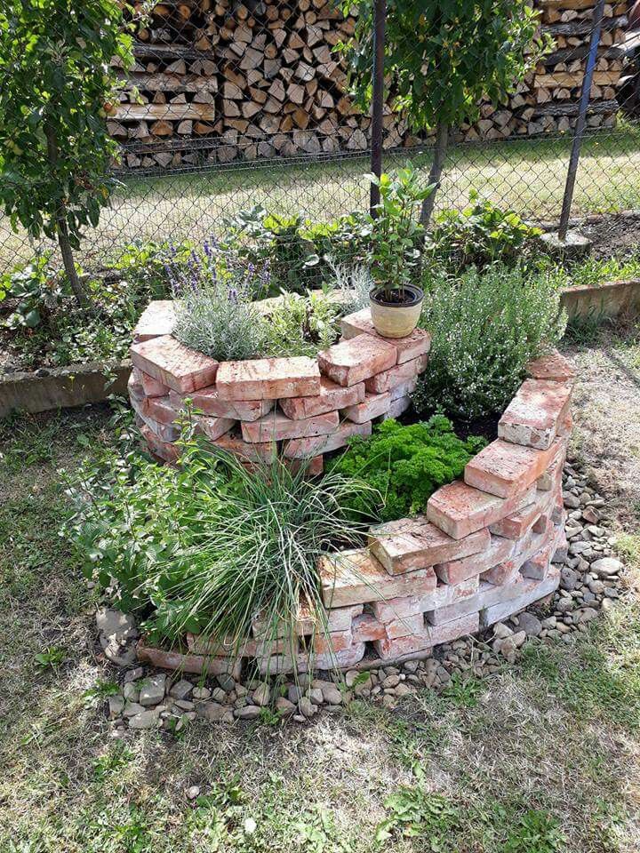 the garden is made out of bricks and has plants growing in it, along with other landscaping items