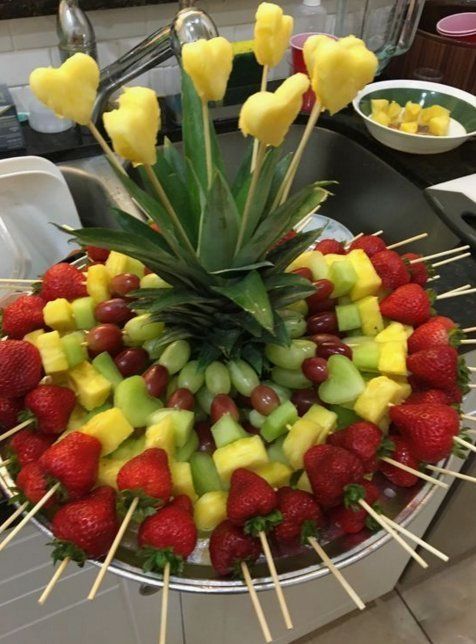 a fruit platter with pineapples, strawberries and bananas