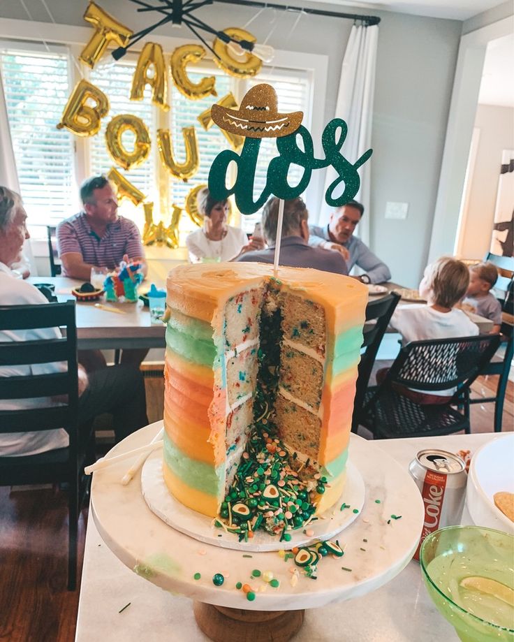 a multi - layer cake with the word boo's spelled out in green and gold