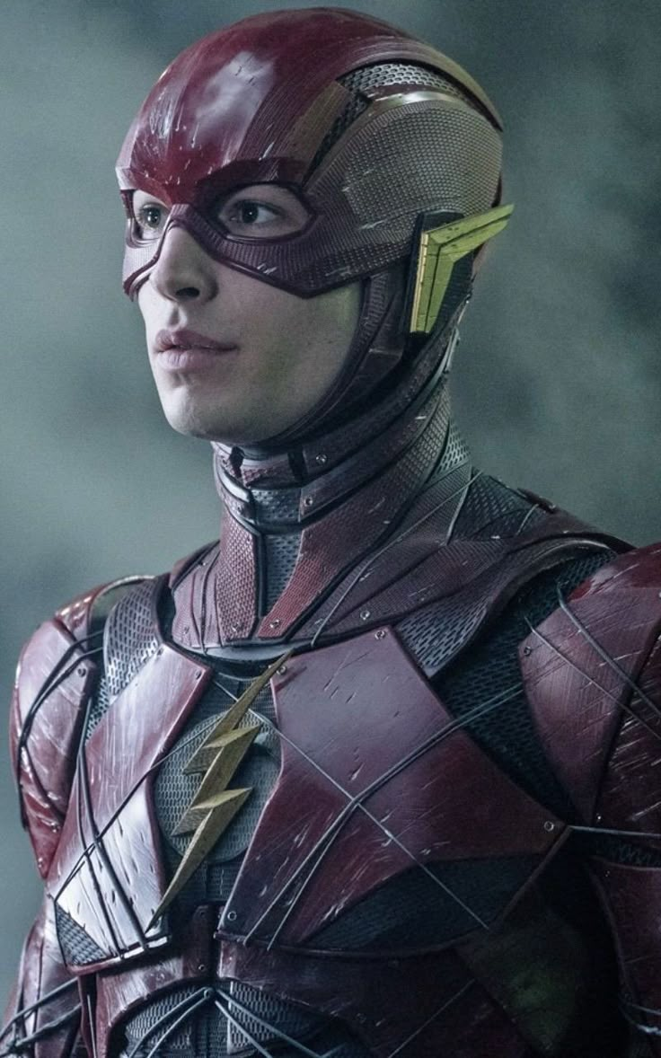 the flash standing in front of a building with his head turned to look like he is wearing