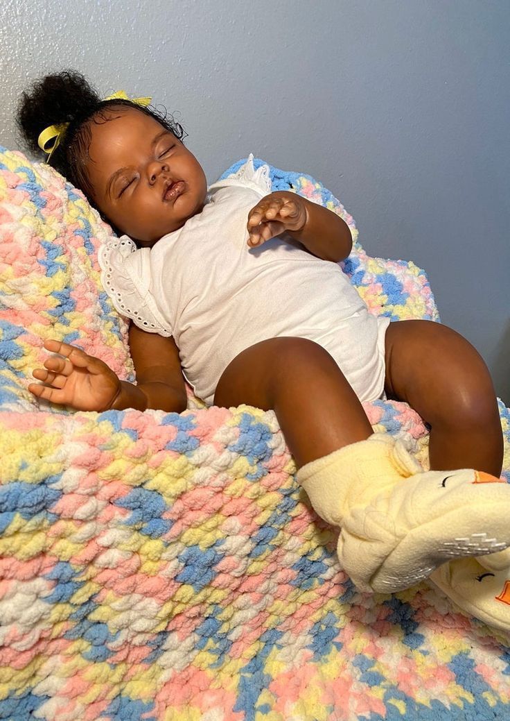 a small child laying on top of a blanket