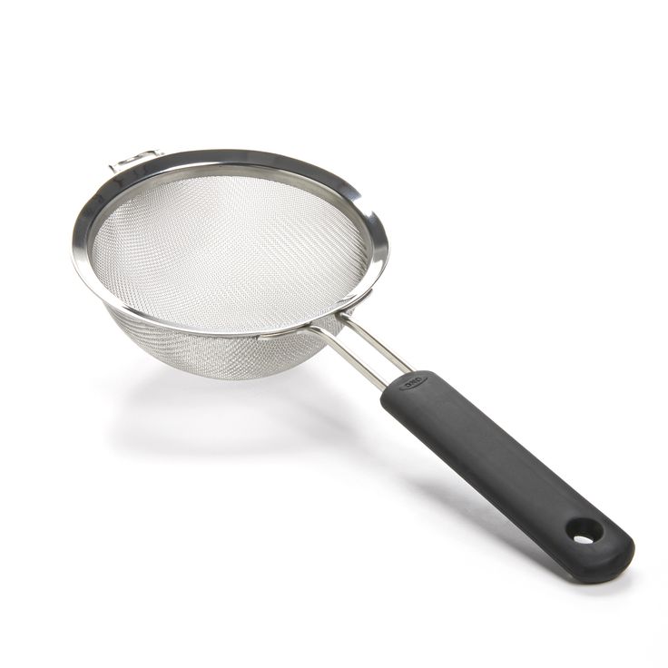 a stainless steel strainer with a black handle on a white background the strainer is empty