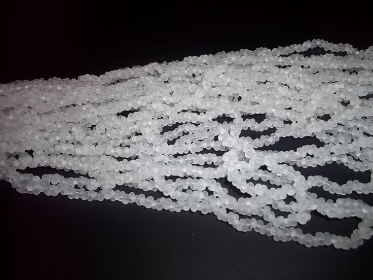 a bunch of white beads sitting on top of a table