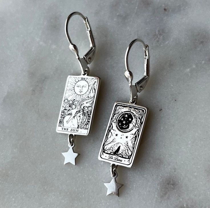 La Luna and The Sun Earings all maden 925 sterling silver . Tarot card silver earrings . Inspired by Tarot cards . Personalization : Just write the two cards you want in the note section when placing your order . If not specified in the note, Luna and sun cards in the images will be sent. La luna illustration REGISTERED LINERWORKS DESIGN. Jewelry Care *Keep you pieces dry and free from moisture *Avoid applying lotions, perfumes or other sprays while you are wearing your jewelry. *Wear your piece Celestial Sterling Silver Jewelry With Matching Earrings, Sterling Silver Celestial Jewelry With Matching Earrings, Symbolic Star Shaped Earrings For Gift, Celestial Style Pierced Sterling Silver Jewelry, Mystical Sterling Silver Jewelry Stamped 925, Celestial Drop Earrings Gift, Celestial Nickel-free Earrings As Gift, Sterling Silver Celestial Jewelry Stamped 925, Nickel-free Celestial Earrings Gift