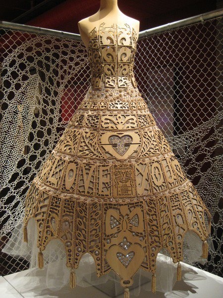 an intricately designed dress on display in a museum