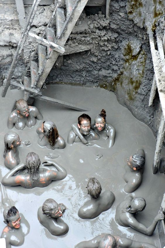 some people are sitting in the mud and having fun