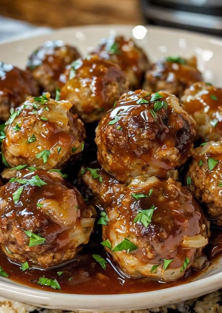 the meatballs are covered in sauce and garnished with parsley