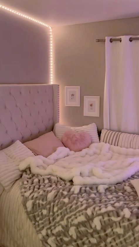 a bed with white and pink blankets on it