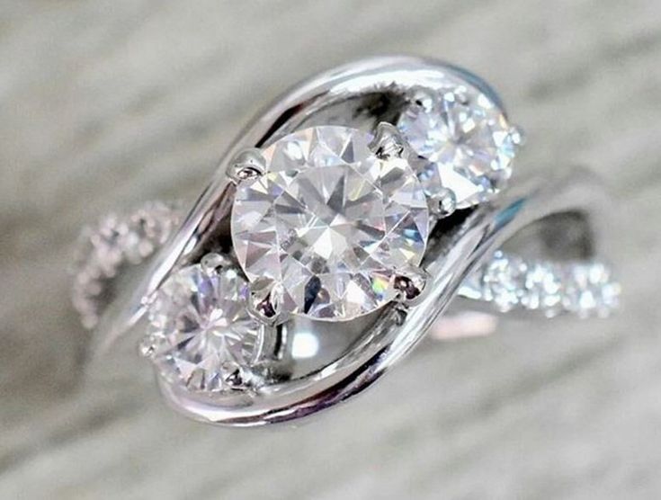 an engagement ring with three diamonds on it