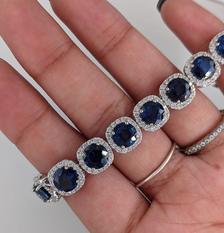 This exquisite bracelet features 6mm round sapphire gemstones surrounded by a halo of round natural earth mined diamonds. Perfect for any event, everyone will be drooling over your new luxury gemstone bracelet!! This Blue Sapphire bracelet also makes a lovely September birthstone gift for your loved ones! This bracelet is made with solid 14K Gold and natural Earth mined SI / G-H diamonds. Luxury Sapphire Diamond Round Bracelet, Luxury Sapphire Diamond Bracelet, Luxury Diamond Bracelets With Halo Setting, Sapphire Tennis Bracelet With Round Diamonds, Sapphire Diamond Tennis Bracelet With Round Shape, Sapphire Diamond Tennis Bracelet With Round Cut, Luxury Formal Bracelet With Halo Setting, Luxury Formal Bracelets With Halo Setting, Luxury Cubic Zirconia Tennis Bracelet With Halo Setting