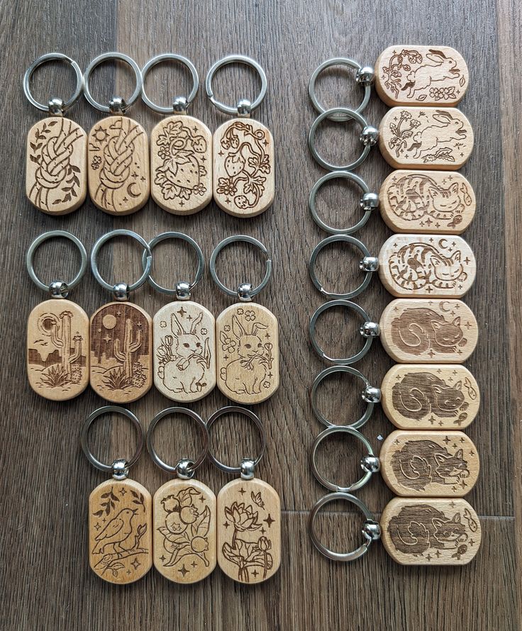 several wooden key chains with different designs on them