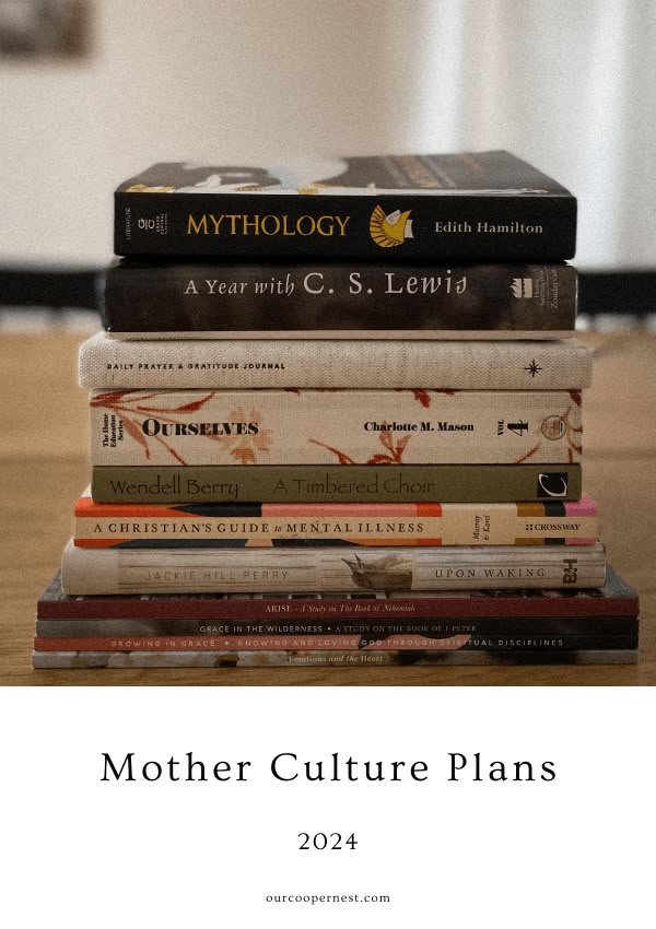 a stack of books sitting on top of a wooden table