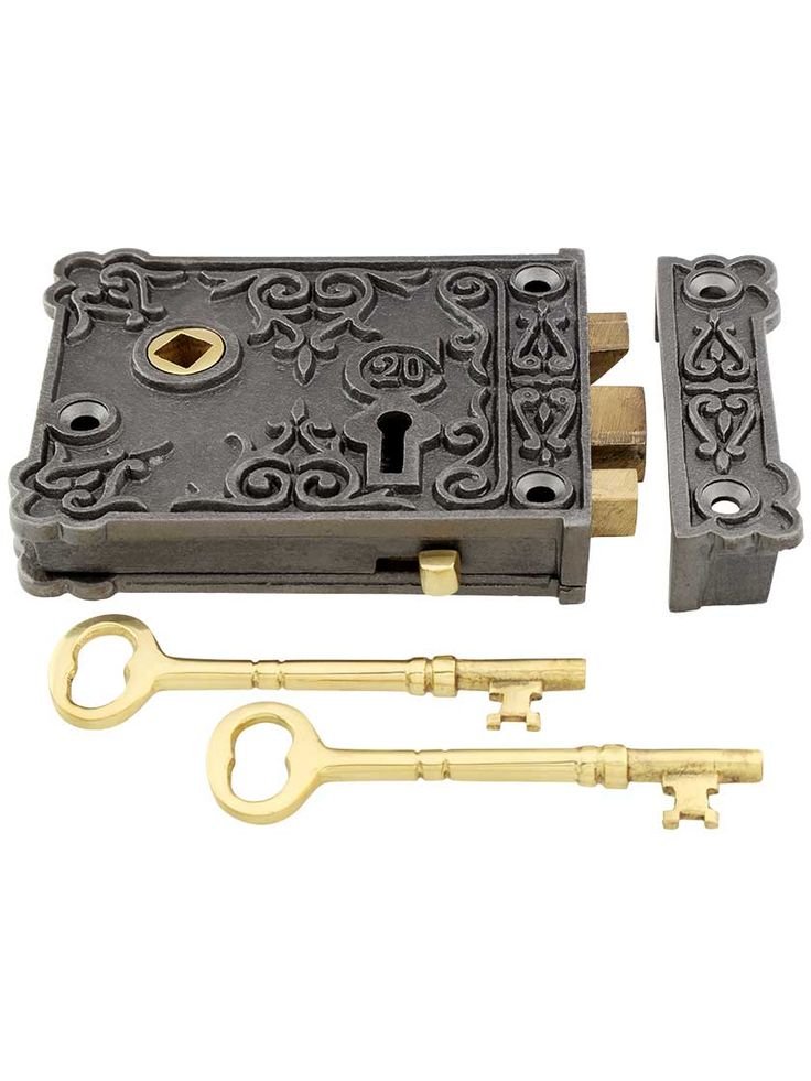 an antique style lock with two keys on the front and one key in the back