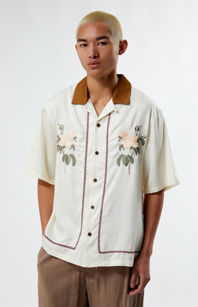 Embrace vintage charm with the Eli Oversized Camp Shirt from PacSun. This shirt features a classic collared neckline, short sleeves, and an oversized fit for a laid-back look. With button closures, floral embroidery and a timeless design, it's perfect for adding retro flair to your wardrobe. 


	Contrast collar
	Short sleeves
	Relaxed fit
	Floral embroidery
	Button closures
	100% Tencel
	Machine washable
	Model is wearing size medium
	Model Measurements: 6'0” Height, 36L Suit, 30” Waist, 32” Inseam Collar Shirt Under Sweater, Abstract T Shirt, Knit Shirts, Pacsun Mens, Oversized Shirts, Shirt Embroidery, Camp Shirt, Contrast Collar, Bowling Shirts