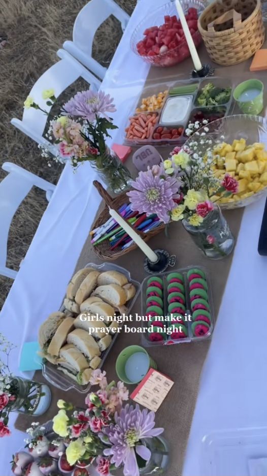 a table topped with lots of food and flowers