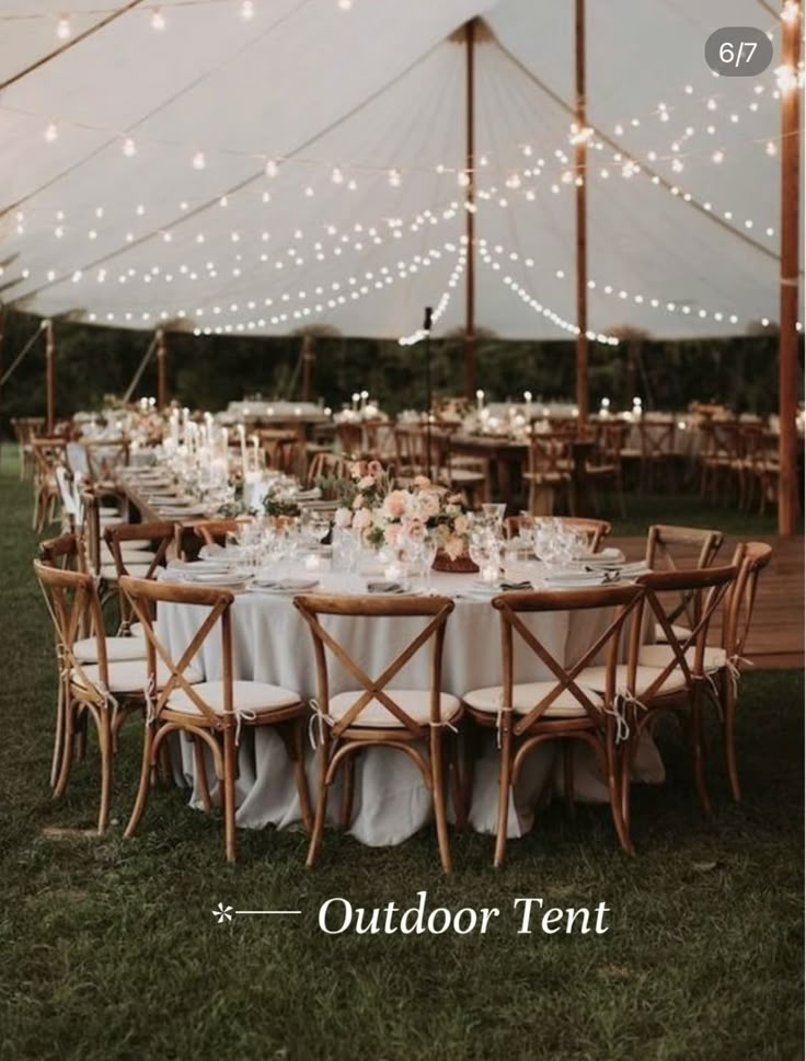 an outdoor tent set up with tables and chairs