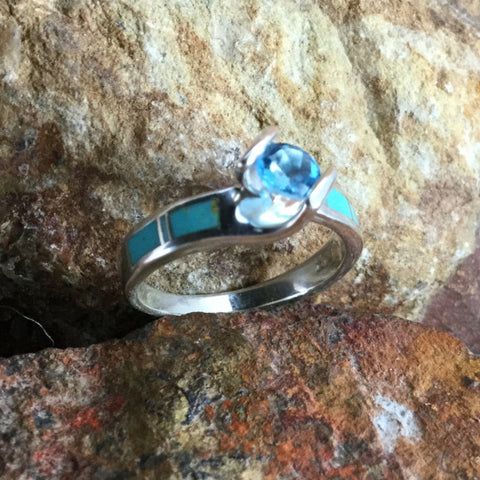 This beautiful Sterling Silver Ring Set, as part of the Arizona Blue Collection features Kingman Turquoise with a Blue Topaz. Engagement Ring Width: Top 5/8"; Shank 1/8" Band Width: 1/4"; Shank 1/8" The ring is designed by David Rosales, one of the finest contemporary Southwest Artists in the world. He is the founder and co-owner of Supersmiths, Inc. of Gallup, NM. Each ring is custom made and carries a lifetime guarantee.