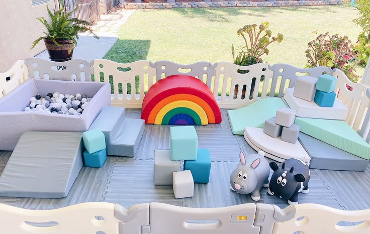 an outdoor play area with toys and furniture