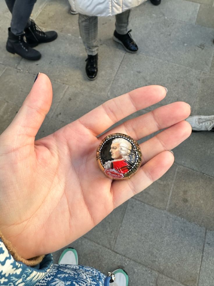 a person holding up a ring with a picture on it