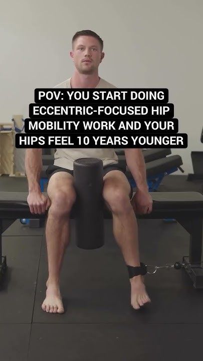 a man sitting on top of a black bench