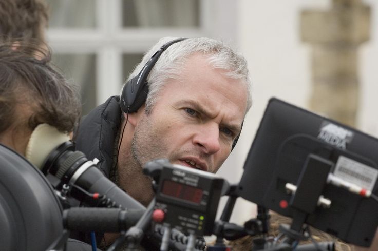 an older man with headphones on is looking at something in front of the camera