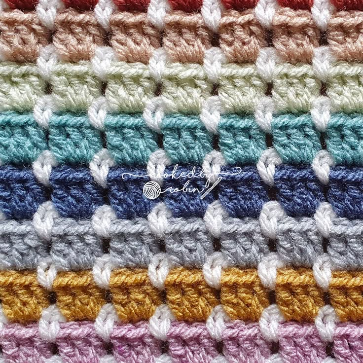 the crocheted blanket is multicolored with different colors