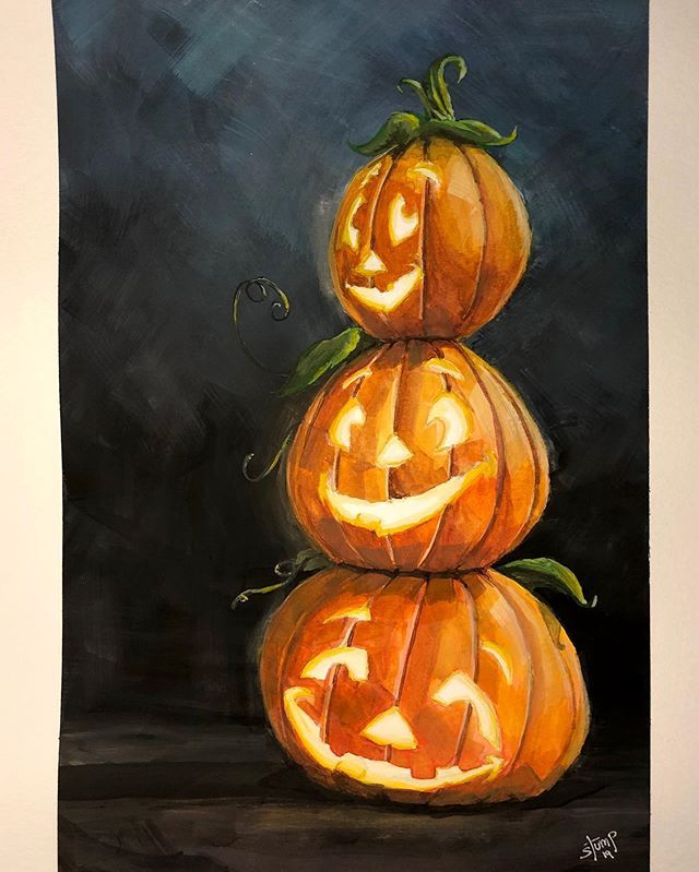 three carved pumpkins sitting on top of each other in front of a dark background