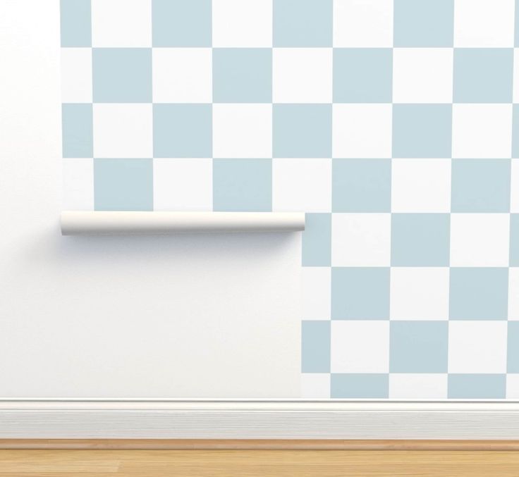 a white and blue checkered wallpaper with a roll of toilet paper on it