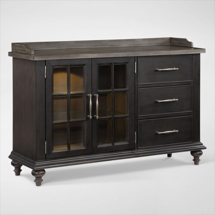 a black cabinet with glass doors and drawers on the bottom, in front of a white background