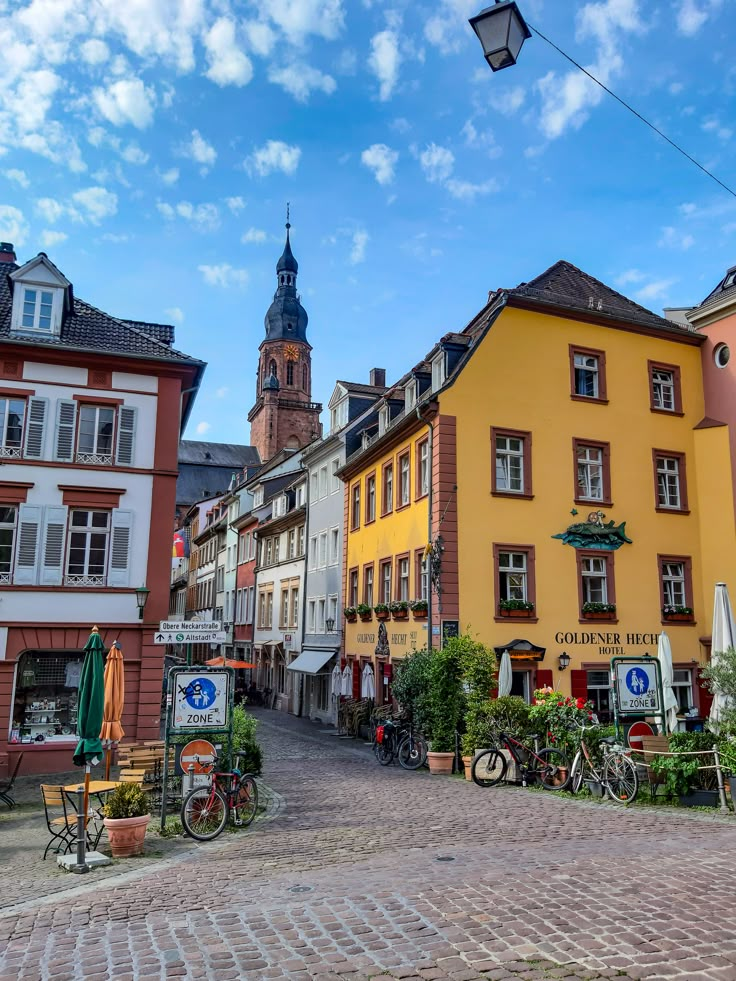 a cobblestone street lined with colorful buildings