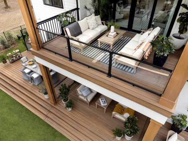 an aerial view of a deck with furniture and potted plants on the top floor