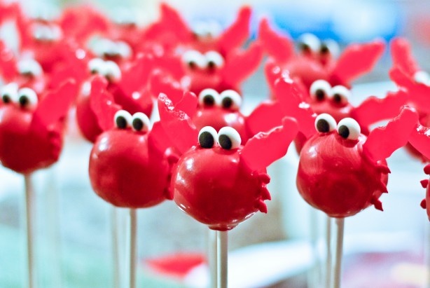 red candies with googly eyes are on sticks