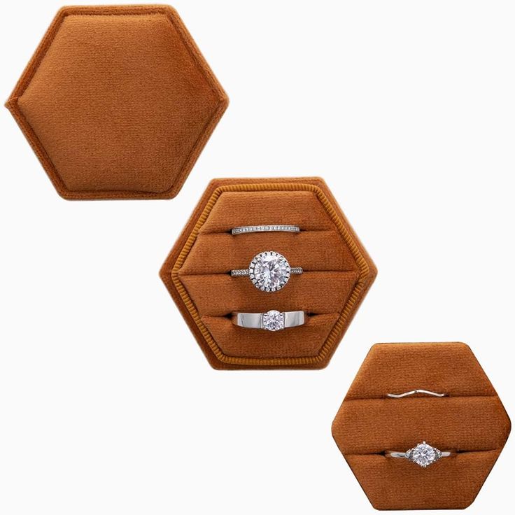 three rings are sitting in an octagonal display case on top of a tan velvet ring box