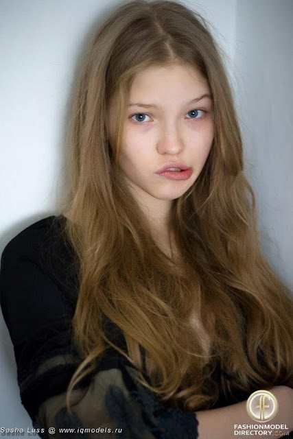 a young woman with long blonde hair posing for the camera