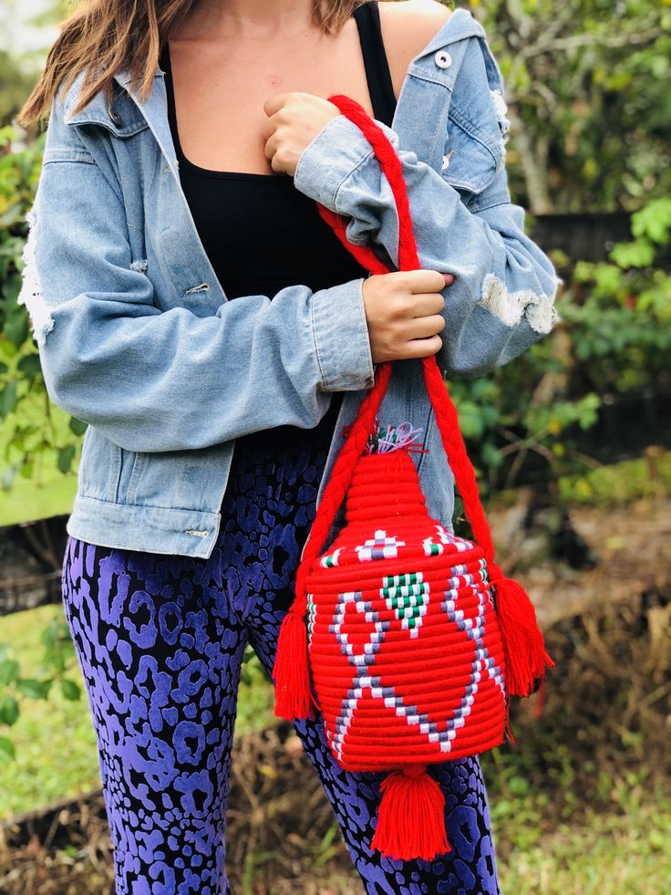 These are traditional Moroccan bread baskets with a twist. Handmade by artisans in Morocco, these bags can we worn as a purse or used to hold your favorite plant in your home. Each bag is one of a kind, no two are the same! DETAILS Cotton covered woven straw Made using the same technique as Moroccan bread baskets Ethically Handmade in Morocco Bag has lid closure Designed in Delray Beach, FL MEASUREMENTS Width 6” in Height Without Top 6.5” in Height With Top 11” in Tassel Length 4”in Strap Drop 1 Handwoven Bucket Shoulder Bag As Gift, Market Bucket Weave Shoulder Bag, Woven Bucket Shoulder Bag As Gift, Woven Shoulder Bucket Bag As Gift, Woven Shoulder Bucket Bag For Gift, Casual Bucket Shoulder Bag With Weaving, Handwoven Red Crochet Shoulder Bag, Artisan Handwoven Pouch Bucket Bag, Red Handwoven Crochet Shoulder Bag