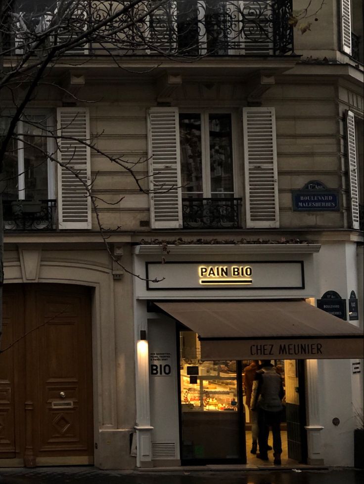 a man is standing in the doorway of a store