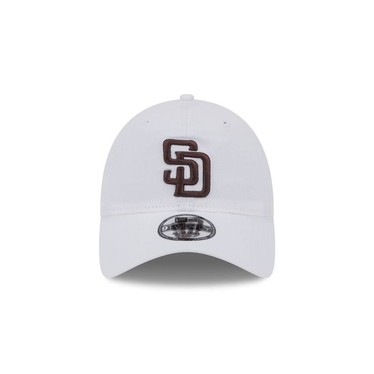 The San Diego Padres White 9TWENTY Adjustable Cap features an embroidered Padres logo at the front panels with a matching woven team logo tag at the adjustable D-Ring closure at the rear. Casual Adjustable Baseball Cap With Logo, Adjustable Cap With Logo Detail, White Baseball Cap With Logo, Adjustable Hat With Logo And Curved Brim, White Baseball Season Hat, Collegiate White Six-panel Hat, White Collegiate Six-panel Hat, White Logo Baseball Cap, White Outdoor Hat With Embroidered Logo