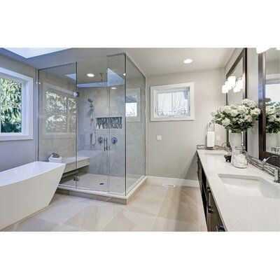 a bathroom with a tub, sink and large mirror