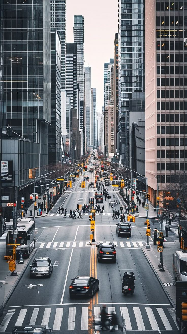 a city street filled with lots of traffic and tall buildings on both sides of it