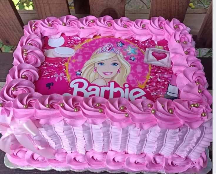 a pink birthday cake with the name barbie on it